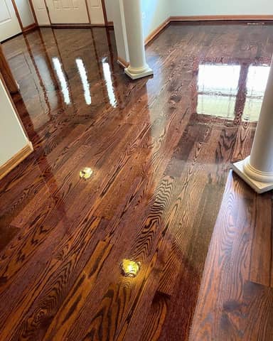 Refinished red oak hardwood with a glossy polyurethane coat