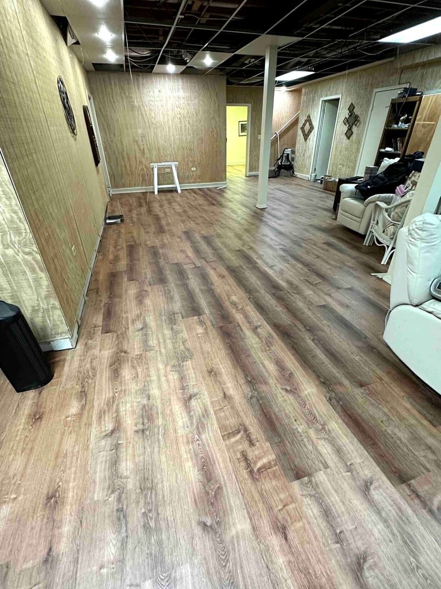 Oak-look laminate flooring in a basement lounge area